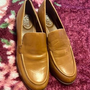 A classic loafer features a round toe for a clean and sophisticated aesthetic.